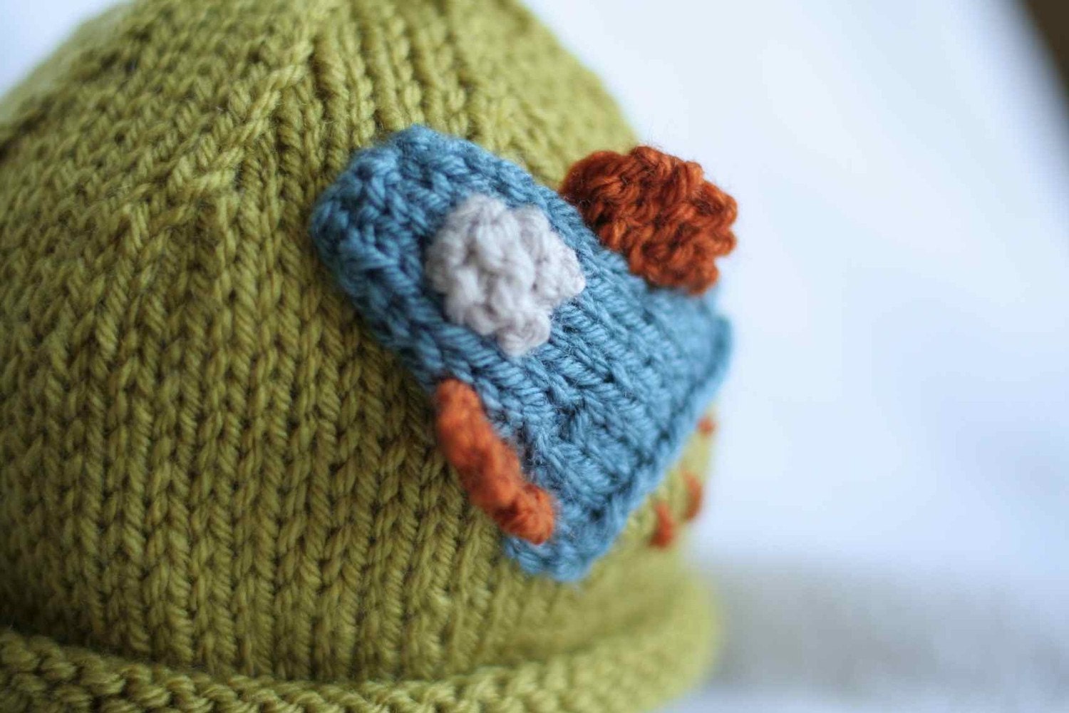 Baby boy knit hat with rocket ship applique.  Sizes newborn to big kid available.