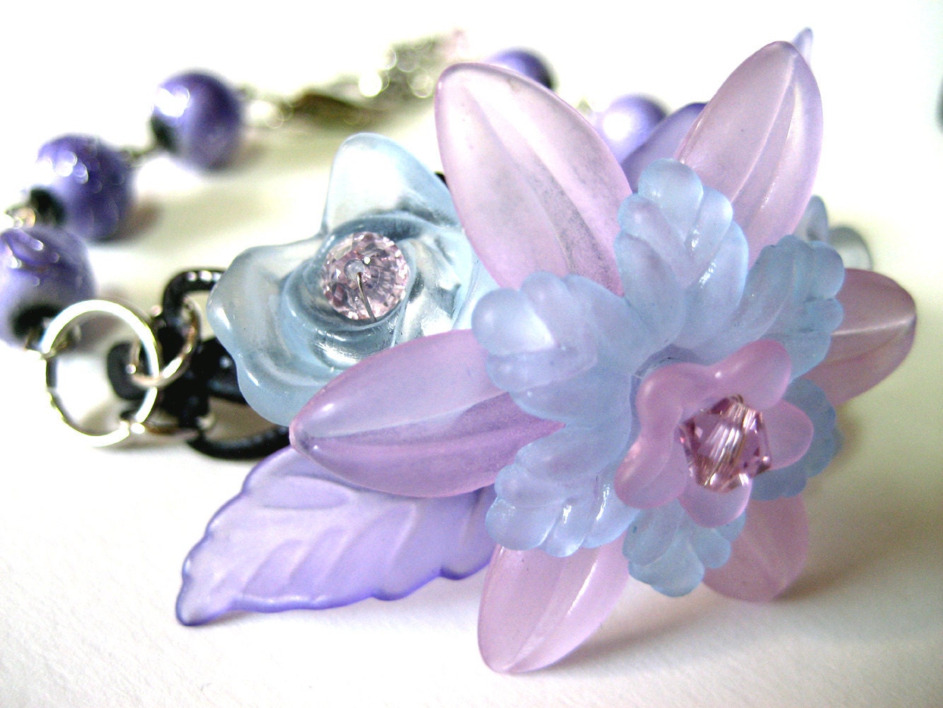 Lilac Flower Bracelet - Pastel Pink Blue Purple Lucite flower cuff with pale purple Swarovski Crystals - by NightsRequiem