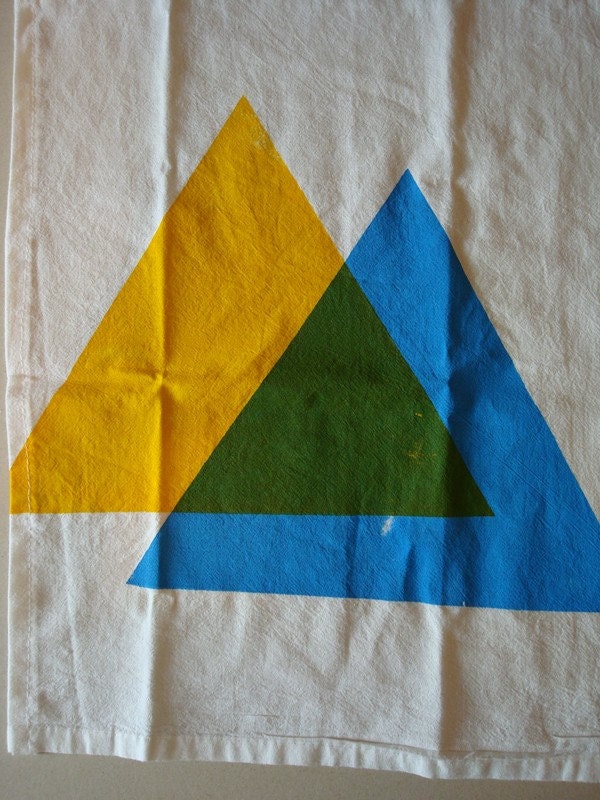 hand screen printed tea towel. blue and yellow makes green triangles.
