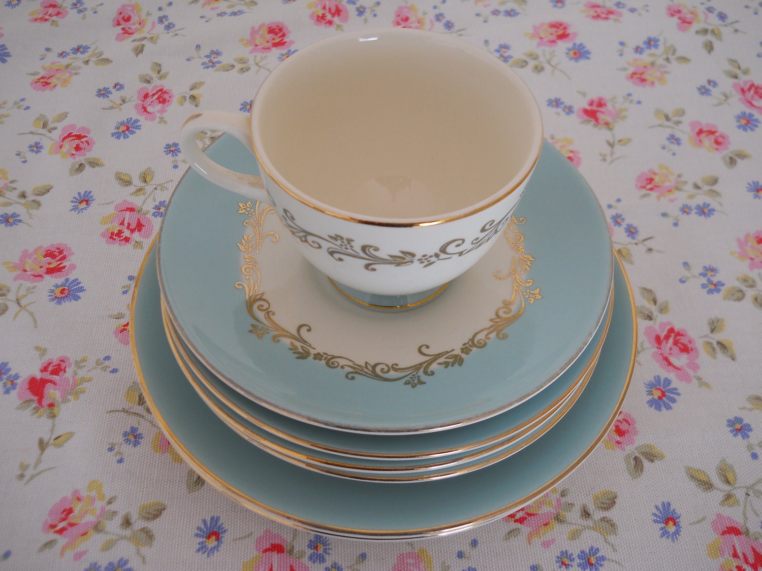 lifetime china company aqua gold crown 7 pieces. tea cup and saucer set, 3 bread and butter plates and 2 salad plates. 7 pieces