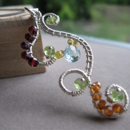 Intricate sterling silver wire wrapped pendant necklace with garnet, peridot, sapphire, and blue topaz