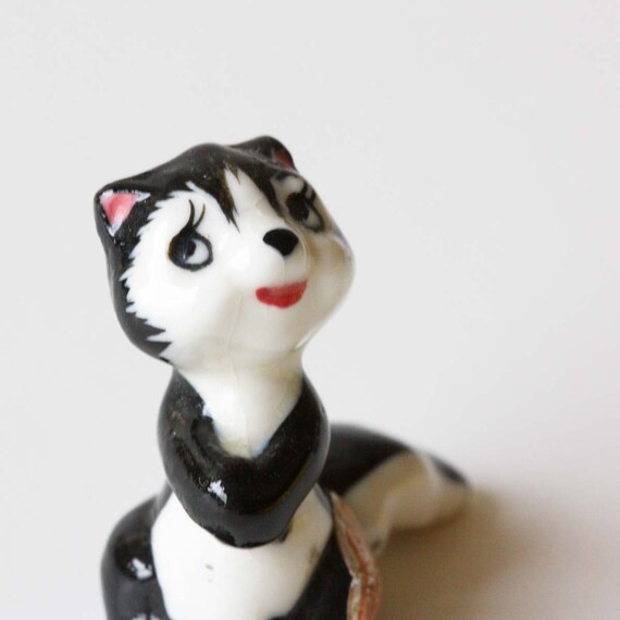 ceramic skunk figurines