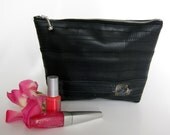 Black recycled bike inner tube cosmetic bag with patch.