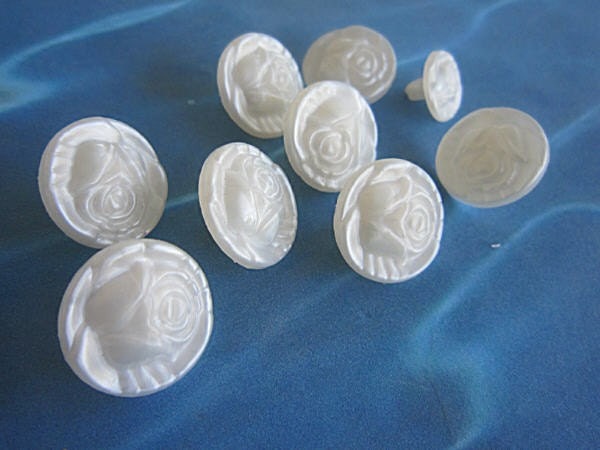 9 White Plastic Buttons with Embossed Roses