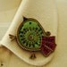 Lime green and magenta felt and zipper bird brooch.