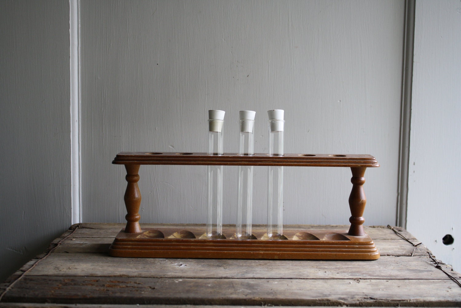 vintage wooden rack with test tubes