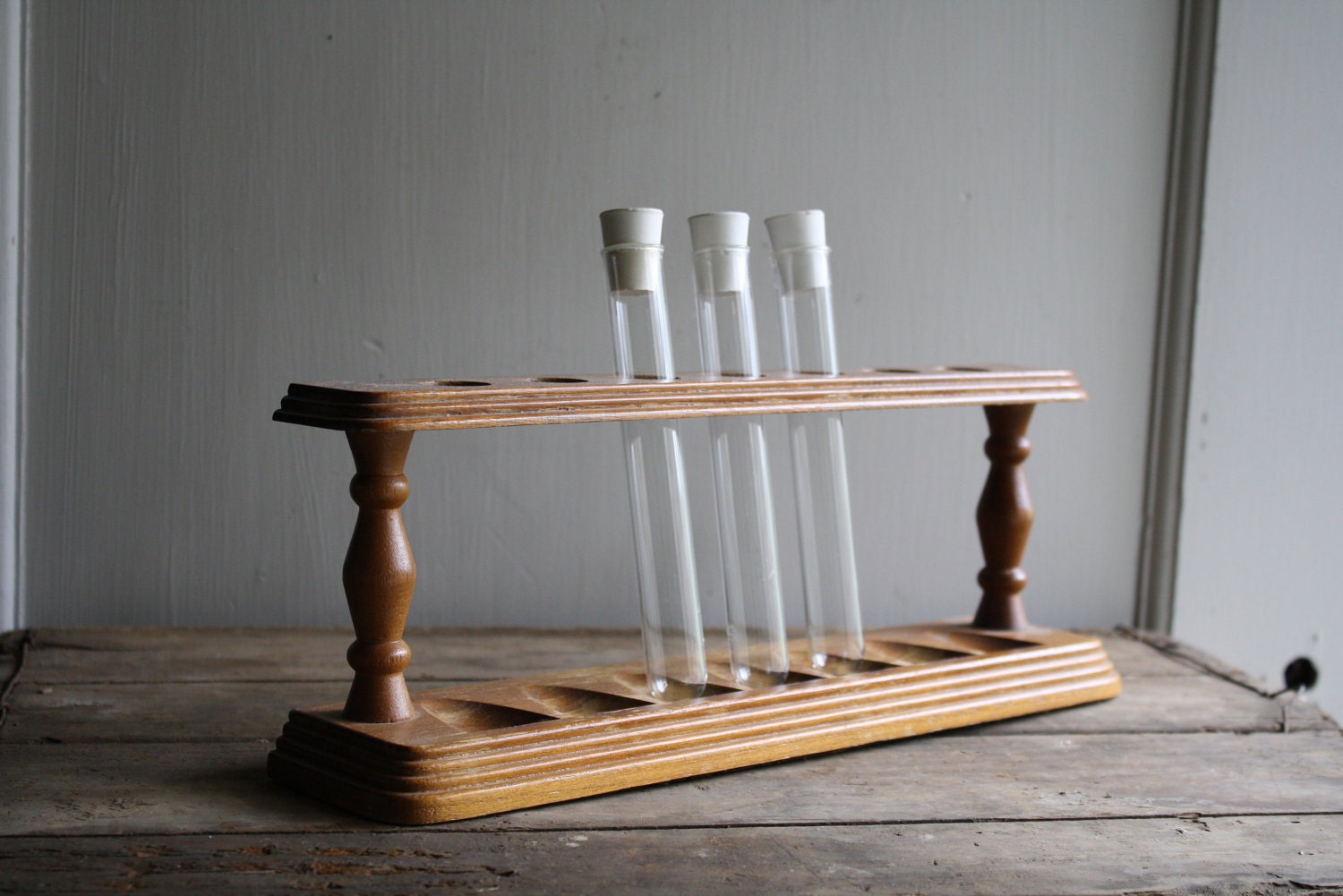 vintage wooden rack with test tubes