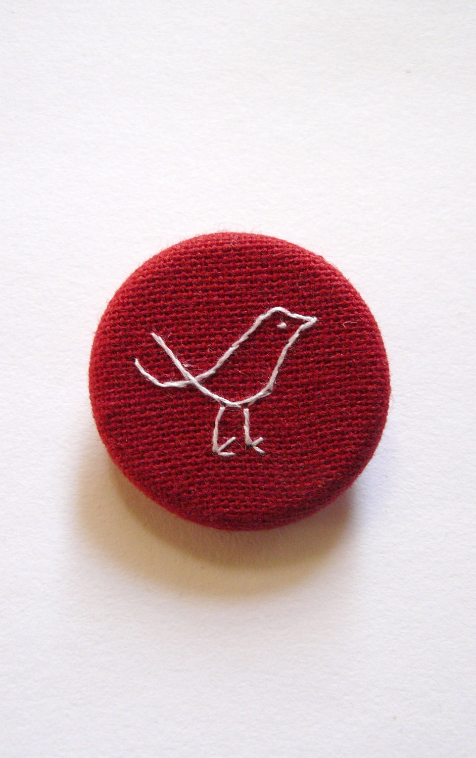 Red Bird Brooch. hand embroidered in white pin badge on organic cotton fabric