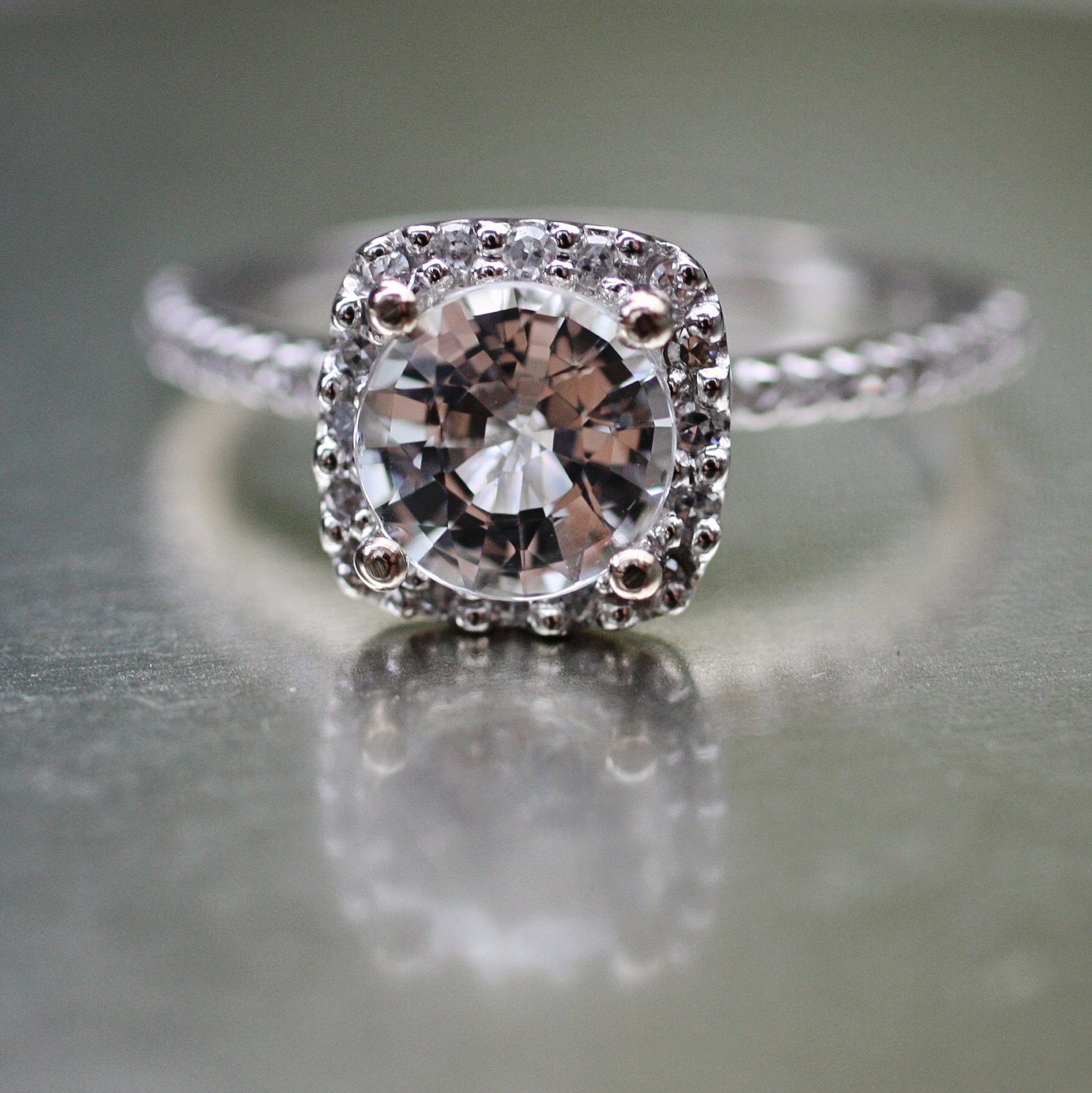Sparkling brilliant sapphire in a 14k white gold cushion diamond setting