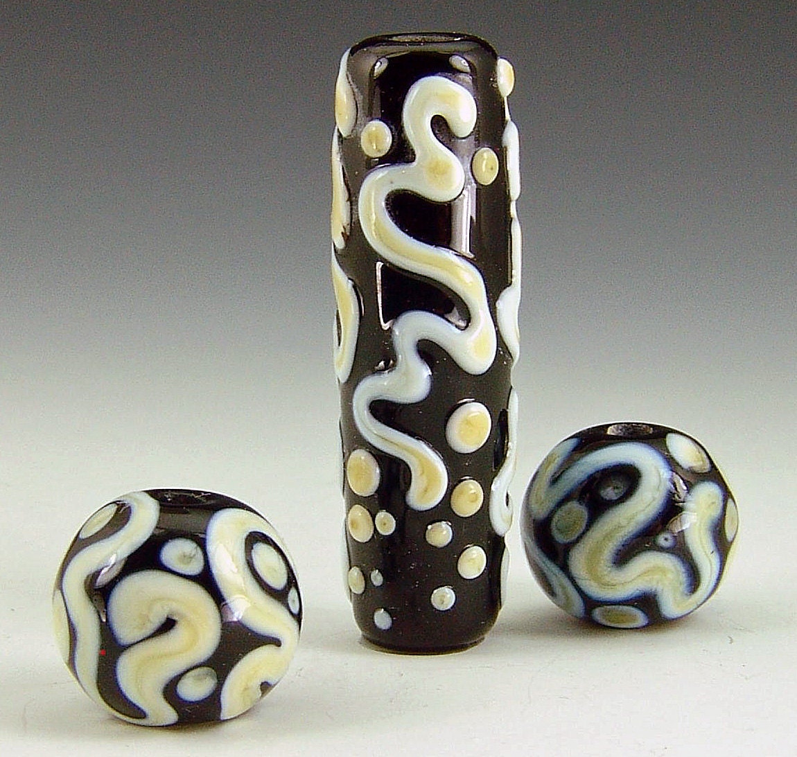 Lampwork bead set in black with ivory.  Focal bead with matching earring set