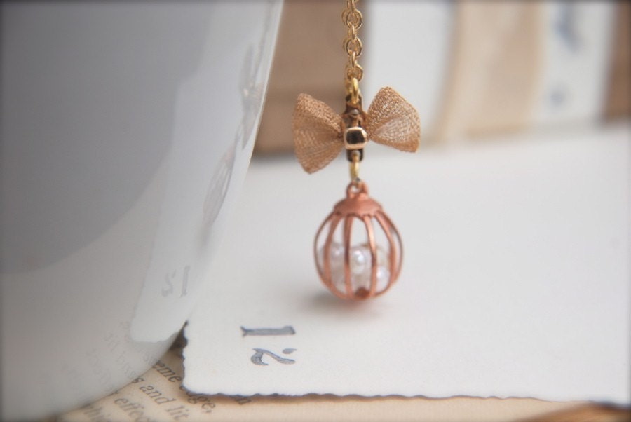 Caged Innocence. A tiny vintage cage and mesh bow necklace.