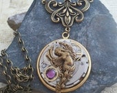 Steampunk winged angel necklace featuring gears and purple crystal