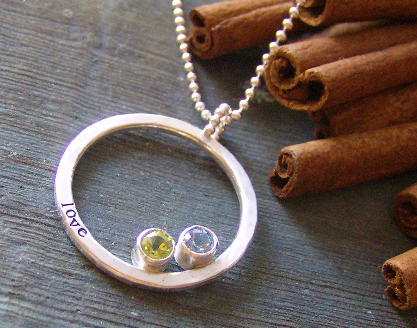 hand stamped personalized eternity ring set with faceted gem stones