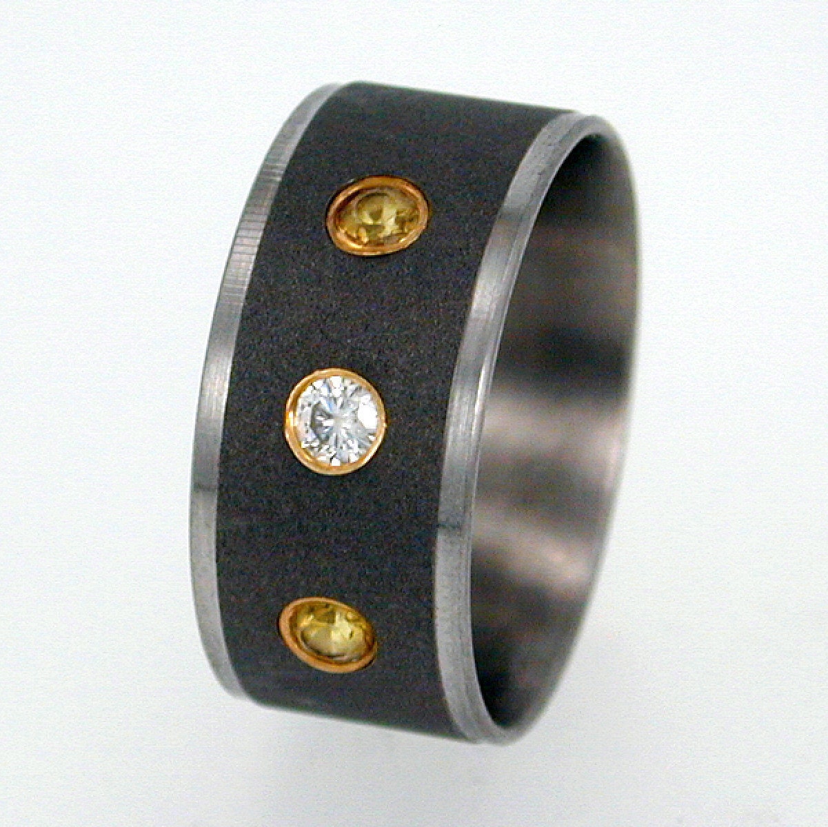 Titanium Ring set with Diamond and Sapphires - The stones are flush set in Gold
