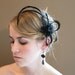 A Striking Birdcage Fascinator Black Flower with Feather Spikes on English Netting