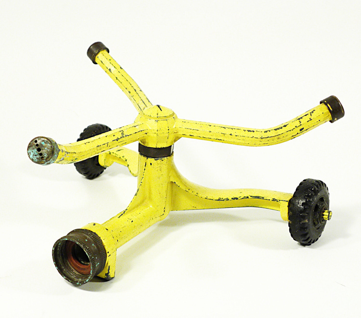 vintage lawn and garden sprinkler by Nelson Manufacturing . bright and sunny yellow . heavy duty cast iron