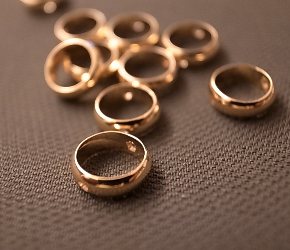 25 pieces of tiny vintage solid raw brass bead in round barrel shape 8 mm across with 2 holes with plating in gold tone