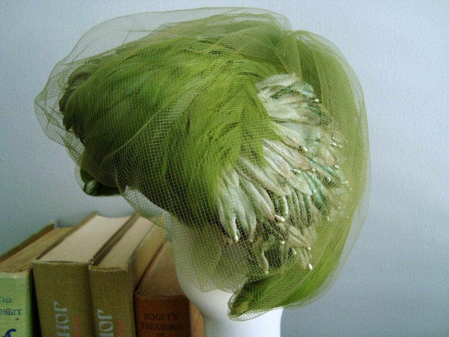 green with envy. gorgeous fascinator hat.