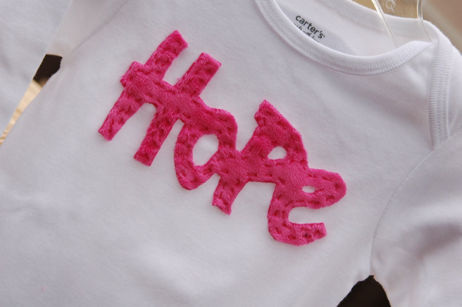 Breast cancer awareness tee or onesie.  Handstitched using soft, minky fabric