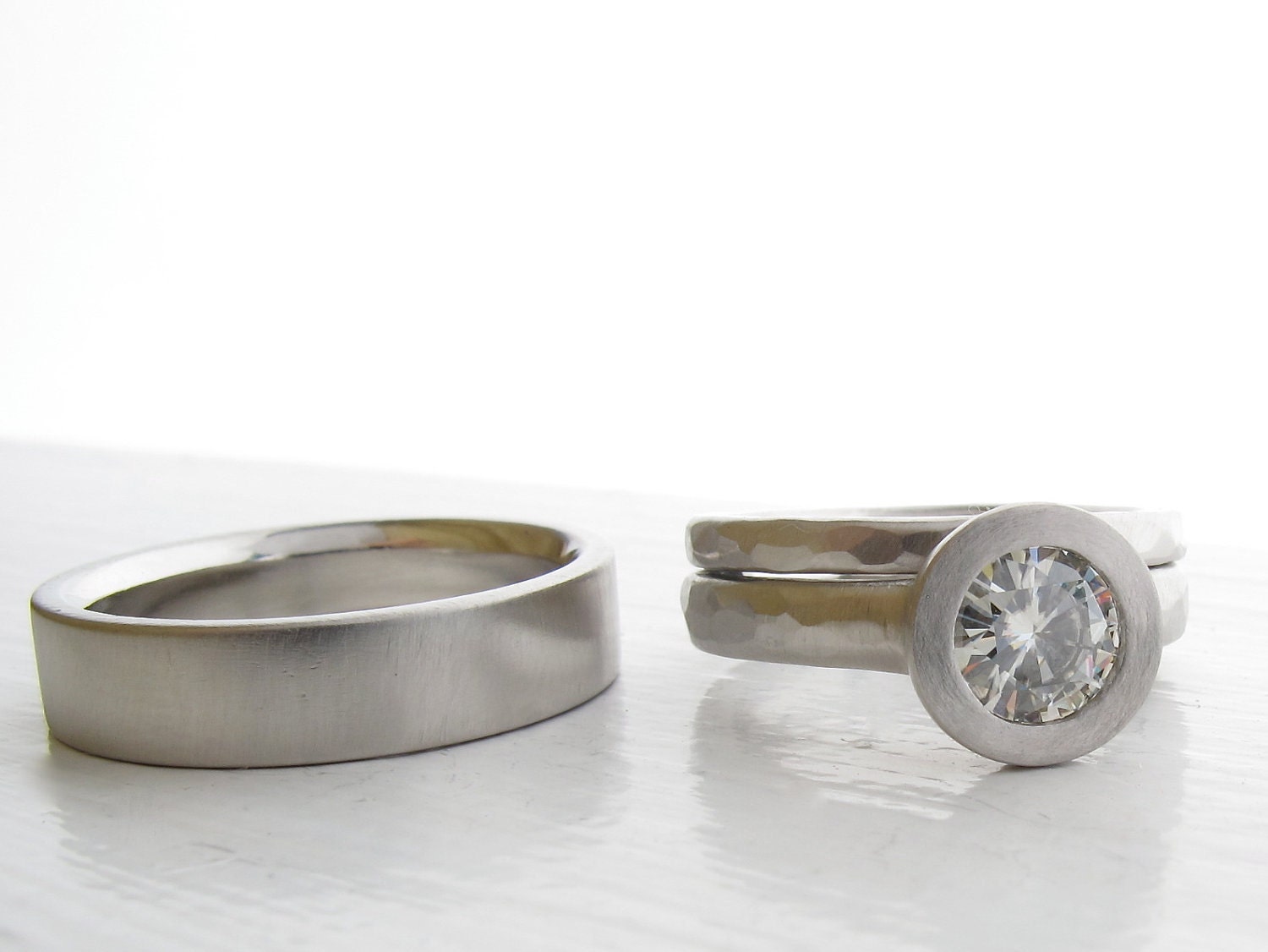 Illumination His and Hers Moissanite and Palladium engagement ring and wedding band set