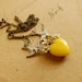 a delicate tattoo - vintage enamel flower and yellow glass heart necklace on brass chain