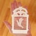 Original hand cut papercut of flying bird in cage - ivory