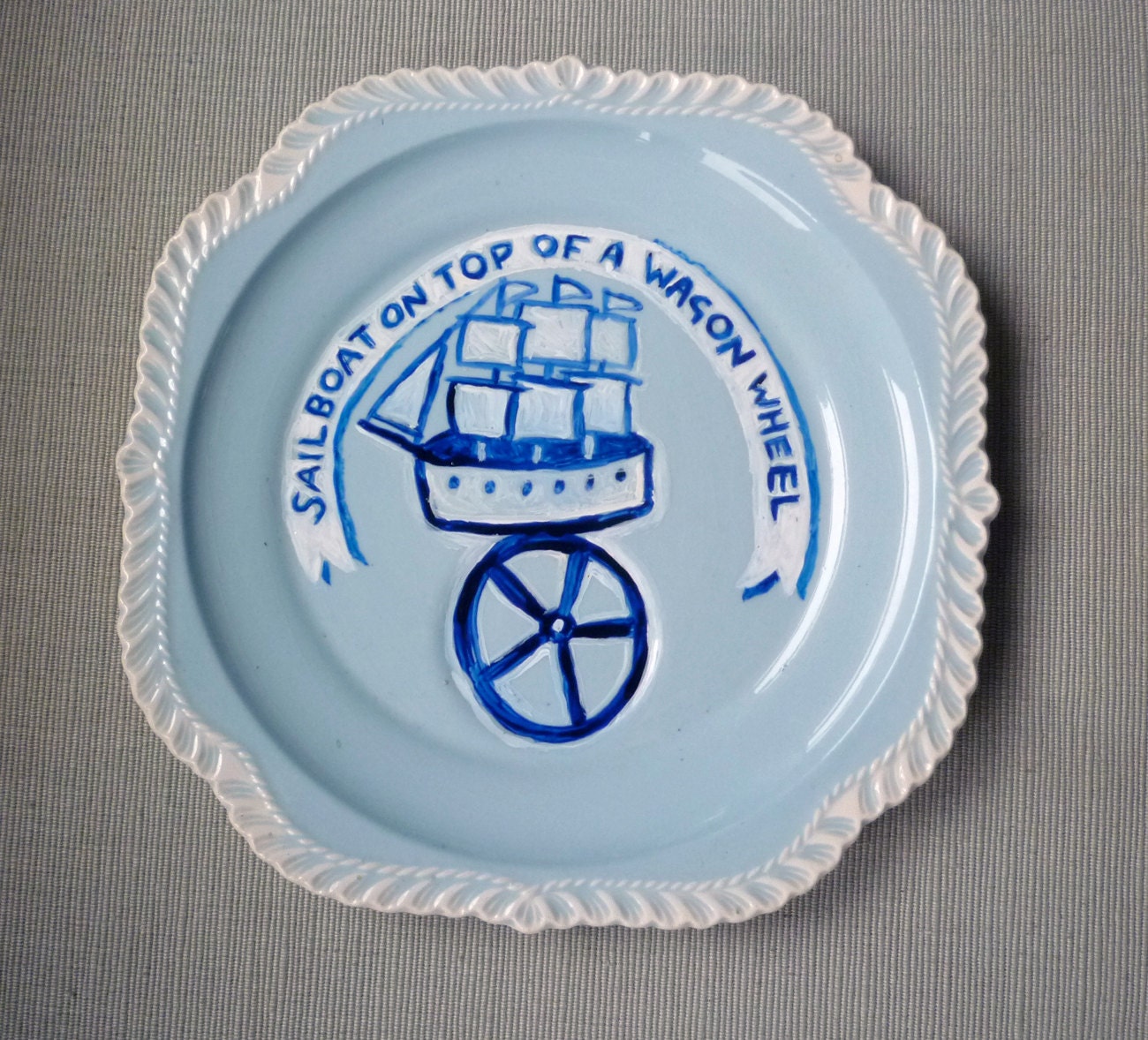 Sail Boat on top of a wagon wheel plate hand painted