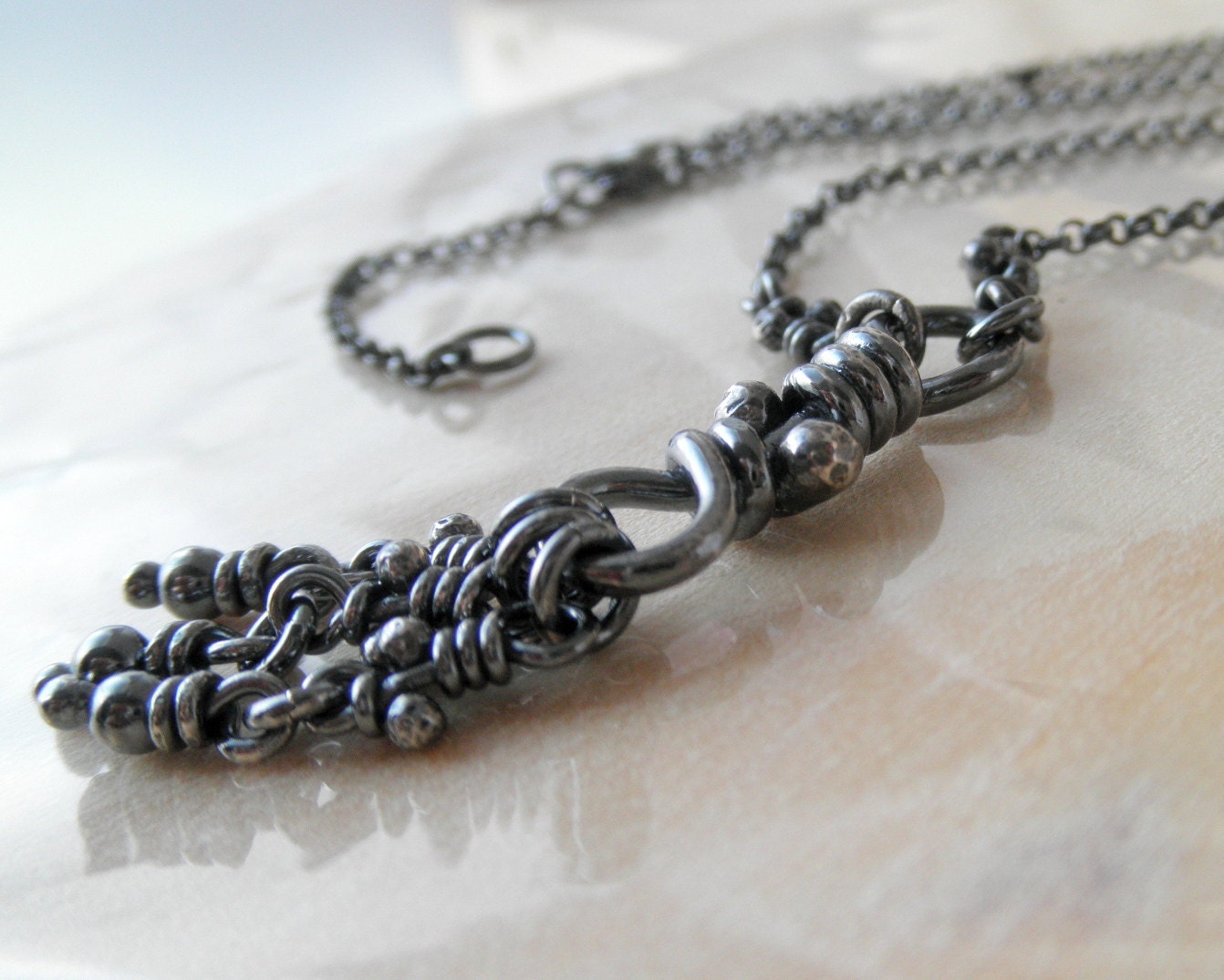 Sterling Silver Necklace. Rustic Oxidized Knot Pendant with dangling little knots and beads. Rollo chain -Nodo with Knots-