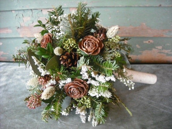 Bridal bouquet made with fresh evergreens and pine cones with birch handle. For your winter woodland natural wedding.