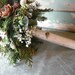 Bridal bouquet made with fresh evergreens and pine cones with birch handle. For your winter woodland natural wedding.