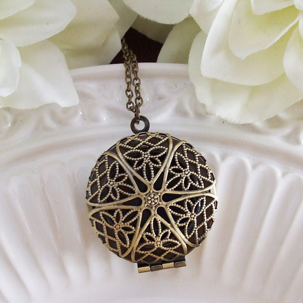 filigree locket necklace . bronze