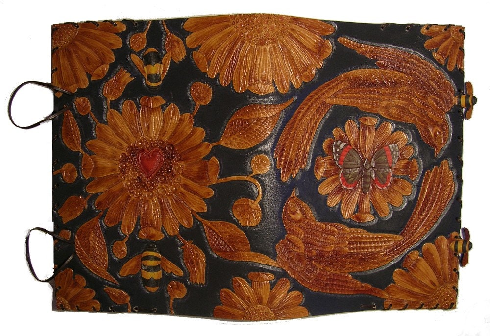 Hand carved leather book cover with birds, butterfly, bees and a heart