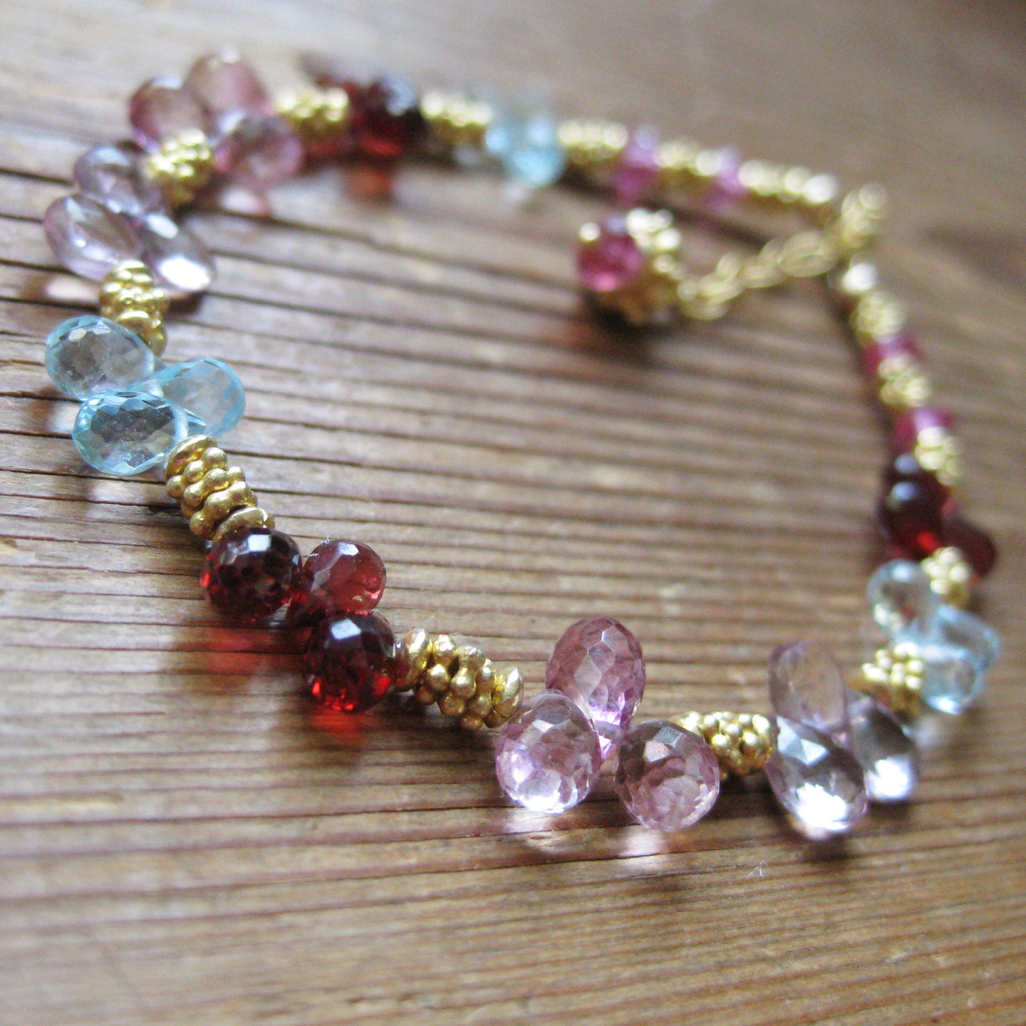 Bracelet of swiss blue topaz & pink topaz and red garnet and vermeil daisies by katecojewelry