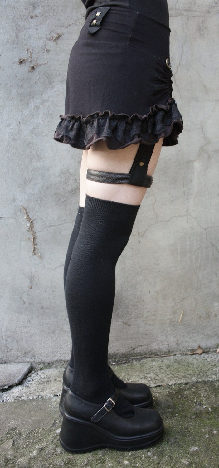 RIVAL... Mini ruffle skirt with leather garter.