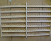 Sewing thread bobbin holder wall unit