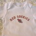 Red Sockies Baby Bodysuit (sizes newborn to 24 months)