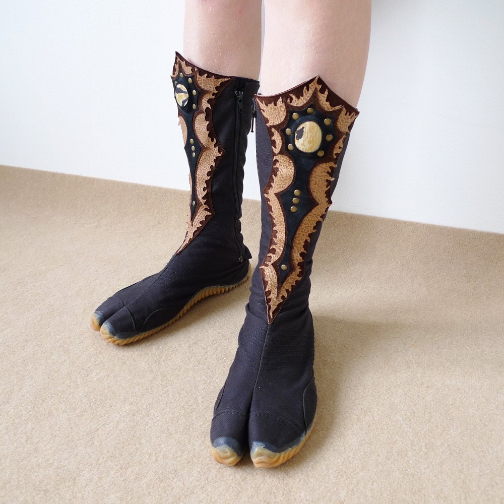 Ninja tabi shoes with custom handmade leather adornments, any size, in black or white color.