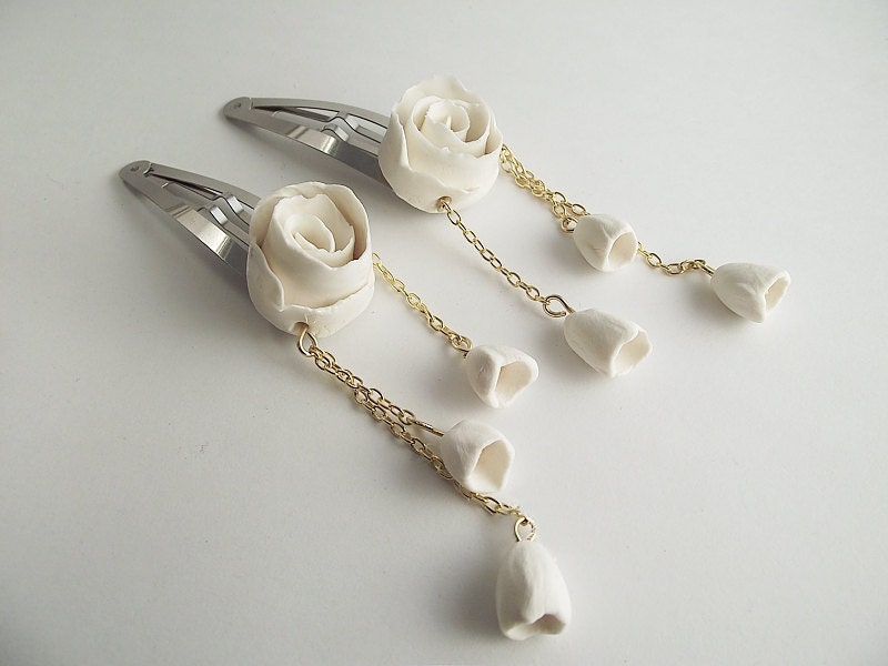 Hairclips - Two hair clips with a porcelain rose and three bells.