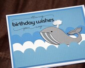 A Blue White and Gray Whale Birthday Card with Water Spout