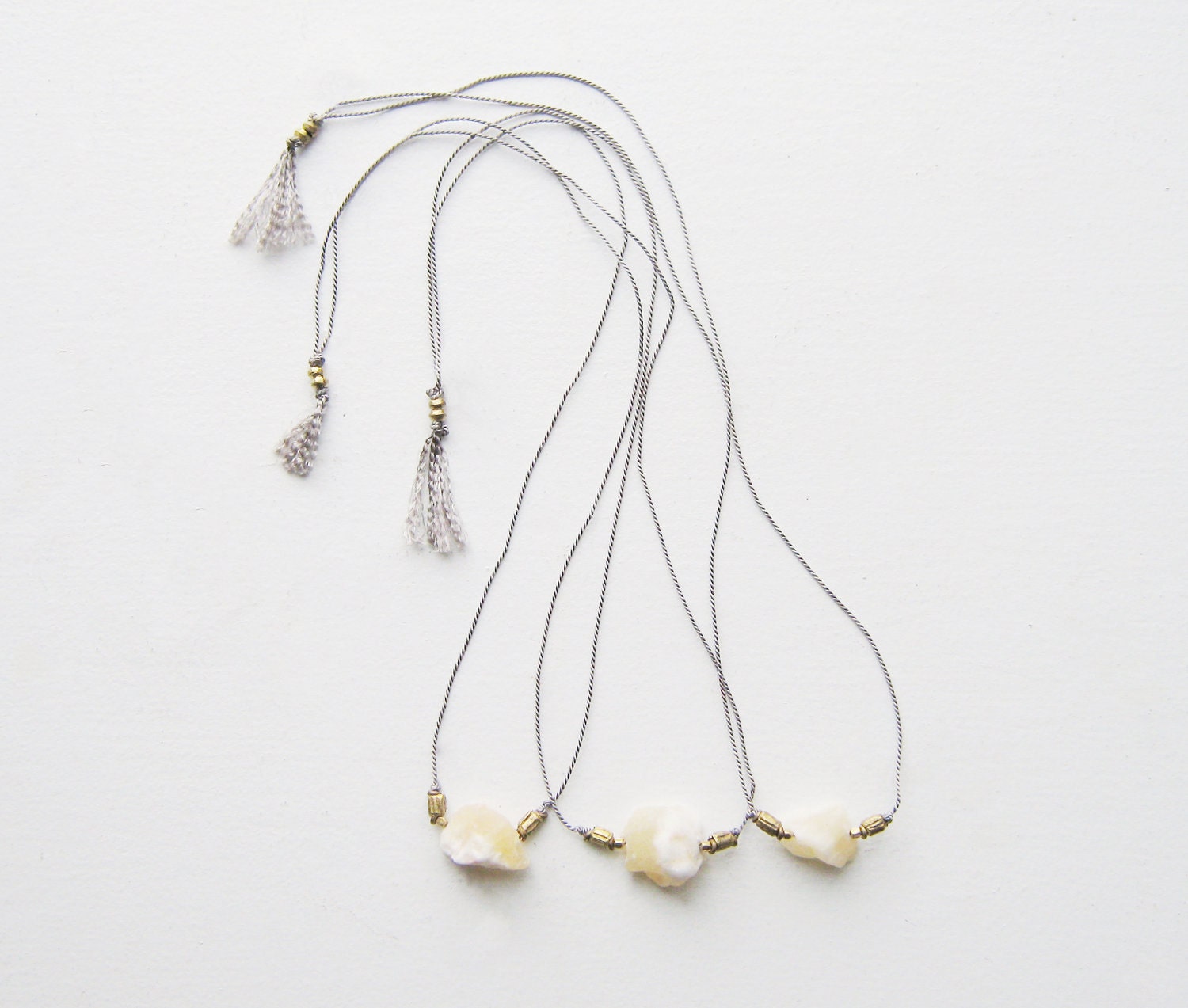 Last one. Raw Yellow Jade on Gray Silk Cord.