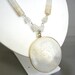 Vintage opaque polished stone necklace with etched Aztec pendant