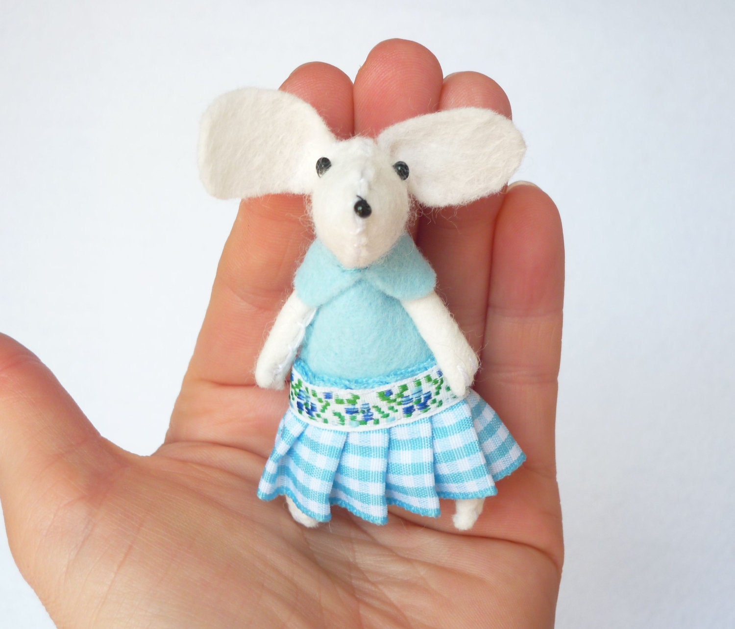White mouse plush in matchbox bed patterned gingham blue