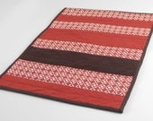Modern Cat Mat: mini quilt in modern red and brown patterned stripes with chocolate brown on back