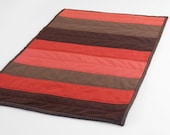 Modern Cat Mat: mini quilt in modern red and brown patterned stripes with dark brown on back