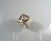 Instead of a Diamond Ring - silver rock set in gold on wide silver band