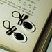Oval black and white enameled earrings