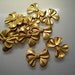 12 small brass bow charms