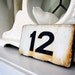 vintage enamel house number from Europe, number 12 black on white with great patina