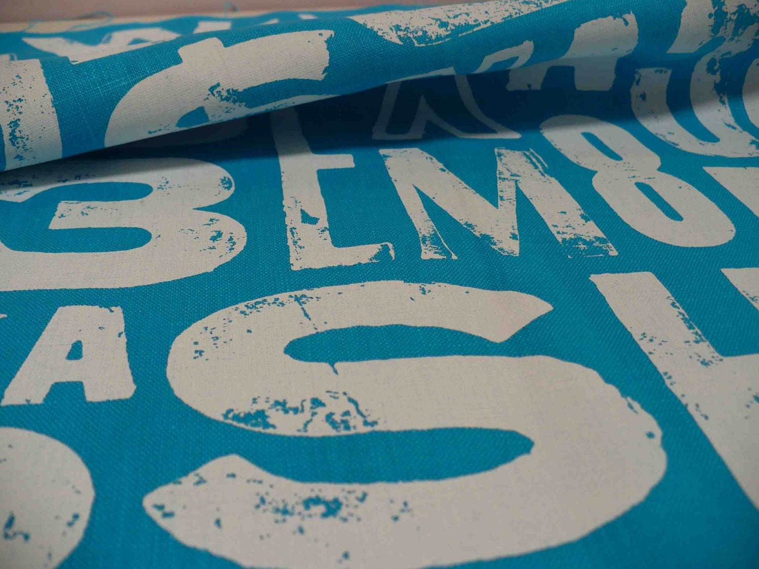 screen printed fabric printed in white on blue linen TYPE design