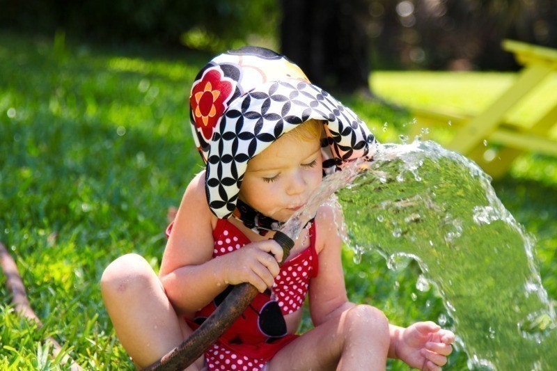 MOD DIVA, a bold little hat in bold and bright reds, oranges, and black, that makes a statement, from Bella Sol Bebe